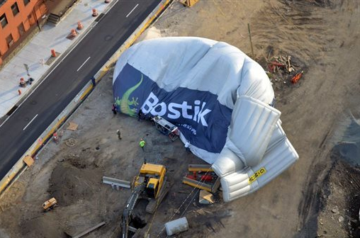 This photo provided by the Philadelphia Police Department shows a blimp that made an emergency landing and deflated at a construction site next to a Philadelphia highway. 