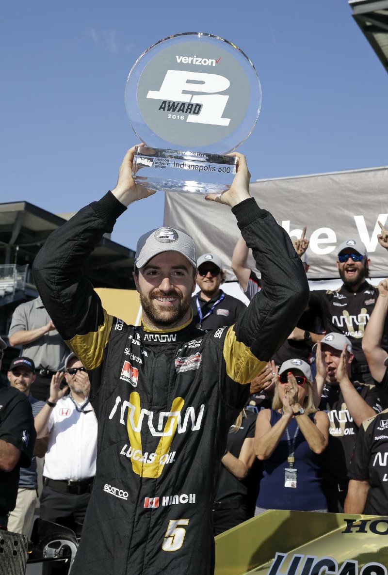 James Hinchcliffe, of Canada, celebrates winning the pole during qualifications for the Indianapolis 500 auto race at Indianapolis Motor Speedway in Indianapolis, Sunday, May 22, 2016. 