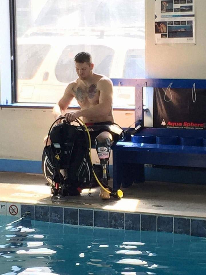 Cody Johnson of Bigelow prepares his scuba gear during a recent practice session at the Dive Shop II in Little Rock. Johnson, who lost part of his left leg in a gun accident, will join other disabled divers next month on a trip to the Caribbean.