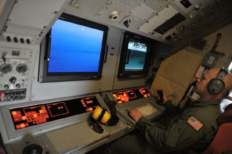 Brandon Fregeau of the U.S. Navy checks monitors Sunday on board a Navy patrol aircraft from Sigonella, Sicily, searching the area in the Mediterranean Sea where EgyptAir Flight 804 from Paris to Cairo disappeared Thursday.