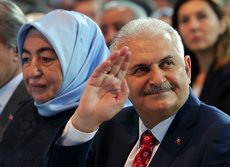 Binali Yildirim, Turkey’s transportation minister and a founding member of Turkey’s governing party, and his wife, Semiha Yildirim, acknowledge supporters during a party congress Sunday in Ankara.