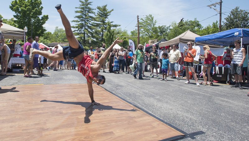 Corey DeAngelis of Fayetteville shows off some dance moves Sunday at the sixth annual Block Street Block Party in Fayetteville. Several thousand people attended the annual street party with events such as waiter races, beer gardens, live music and vendors.