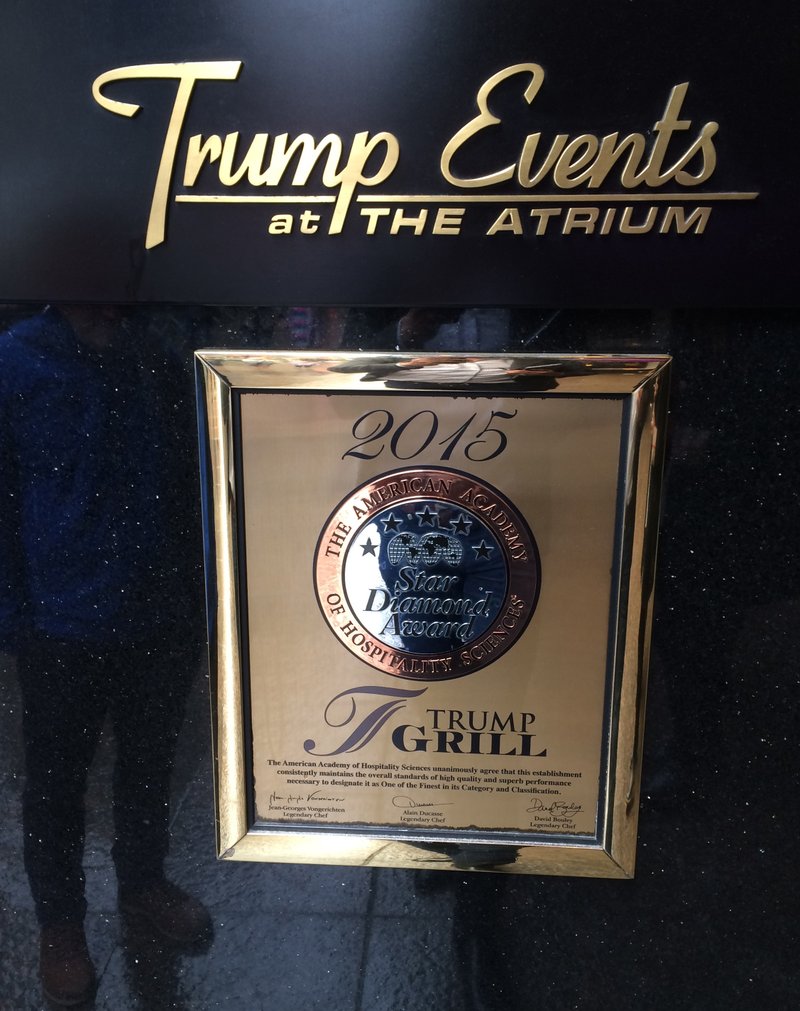 In this May 3, 2016 photo, a plaque awarding the Trump Grill five stars by the American Academy of Hospitality Sciences is seen displayed in the Trump Towers in New York. Joseph Cinque, a longtime friend of developer and presidential candidate Donald Trump, has run American Academy of Hospitality Sciences for years. A review by The Associated Press shows that more than a dozen of its board trustees are Trump friends, relatives or business associates. (AP Photo/Jeff Horwitz)