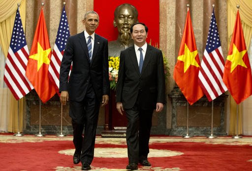 U.S. President Barack Obama, left, and Vietnamese President Tran Dai Quang walk to a meeting after shaking hands at the Presidential Palace in Hanoi, Vietnam, on Monday, May 23, 2016. 
