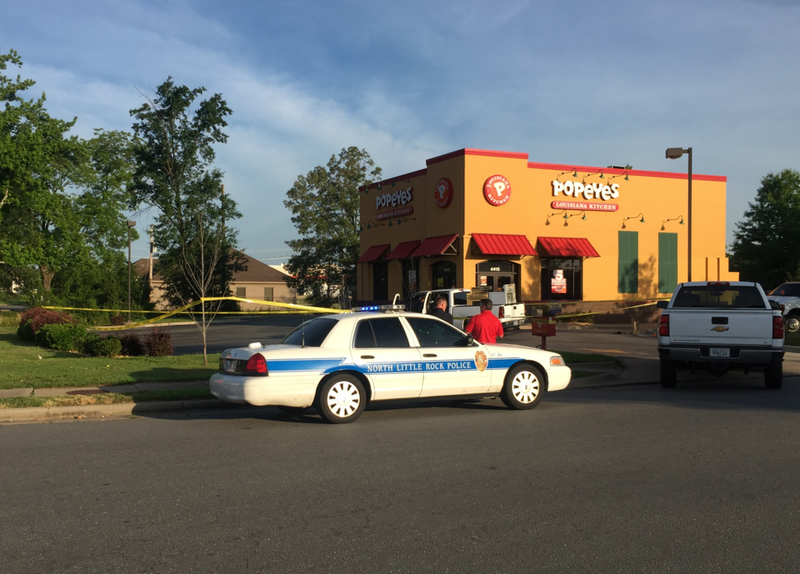 Police work a crime scene in the parking lot of the Popeye's on McCain Boulevard in North Little Rock after a shooting left one person dead early Monday morning.