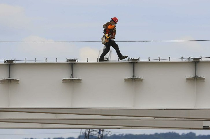 A worker maneuvers Thursday across large steel structures that will be part of the new Broadway Bridge between Little Rock and North Little Rock.
