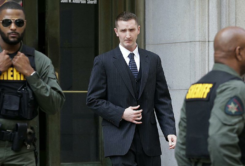 Edward Nero, one of six Baltimore police officers charged in the death of Freddie Gray, leaves a Baltimore courthouse Monday after being acquitted of all charges.