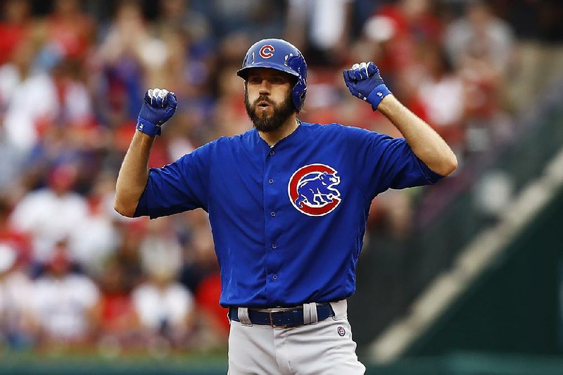 Jason Hammel of the Chicago Cubs celebrates after hitting a two-RBI double in the first inning Tuesday against the St. Louis Cardinals at Busch Stadium in St. Louis. The Cubs scored six runs in the first inning en route to a 12-3 victory.