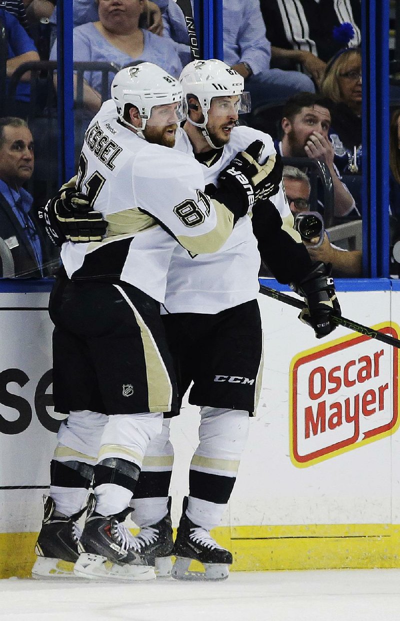 Pittsburgh Penguins right wing Phil Kessel (81) congratulates Sidney Crosby (87) after his second-period goal in the Penguins 5-2 victory over the Tampa Bay Lightning Tuesday night in Tampa.