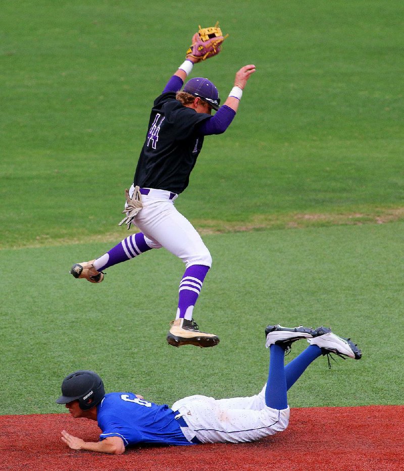 Poyen’s Lathan Wylie, playing for the South team, leaps to pull in a wild throw from the catcher as Greenbrier’s Cody McKnight safely steals second base for the North team Tuesday during the first inning of the Central Arkansas All-Star Game at Gary Hogan Field in Little Rock. The South defeated the North 8-3.