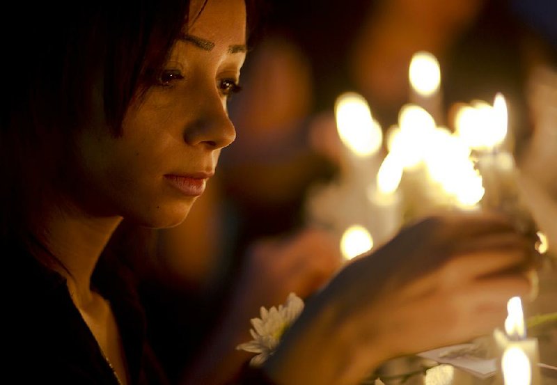 An Egyptian journalist lights candles during a vigil for the victims of EgyptAir Flight 804 in front of the Journalists’ Syndicate in Cairo on Tuesday. 