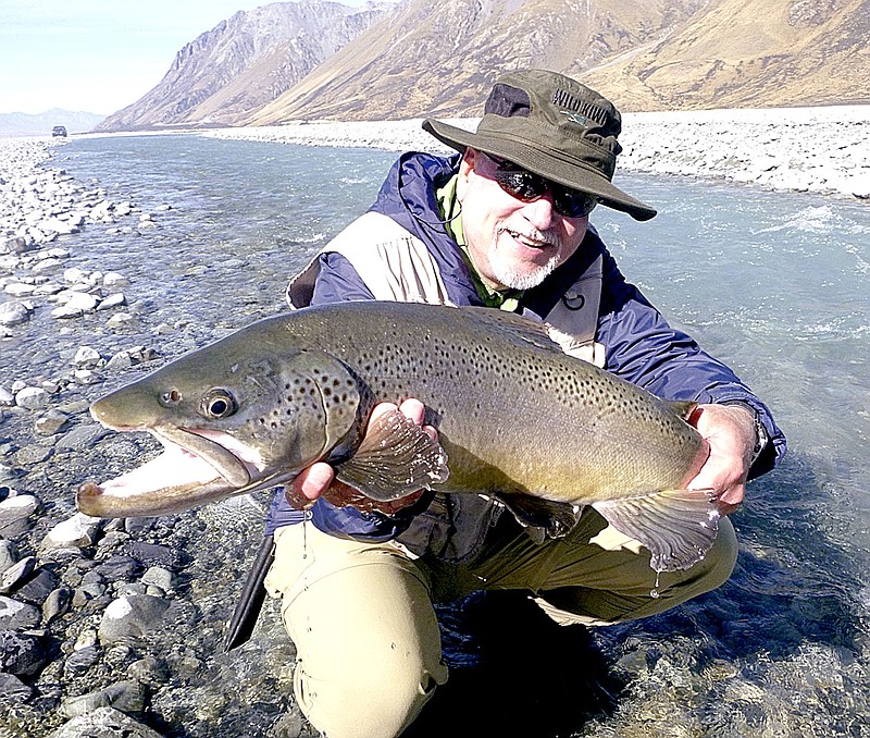 Photo submitted Gary Henderson displays a trout he caught while fishing in New Zealand.