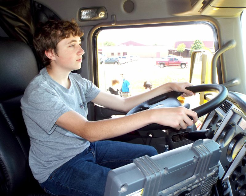 Photo by Randy Moll Jacob Skaggs, a student at Gentry Middle School, sat behind the wheel of a tractor-trailer rig during a &quot;Share the Road&quot; safety presentation by the Arkansas Trucking Association on May 10, 2016, at the Gentry Middle School campus. Students were also introduced to truck driving as a possible career during the safety presentation.