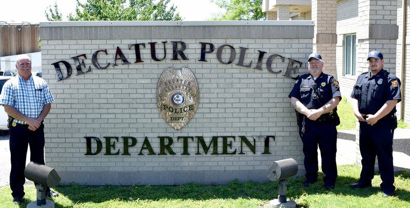 Photo by Mike Eckels Chief Terry Luker (left), Sergeant Joe Savage, and Officer Austin Cobb stand in front of the Decatur Police Department&#8217;s new sign May 13 in preparation for Police Week May 12 to 18.