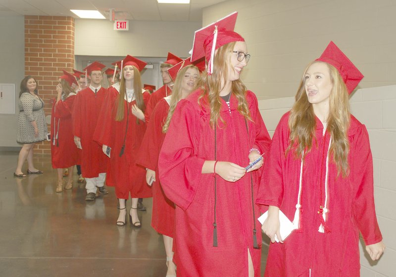 CAROL BUNDSGAARD SPECIAL TO ENTERPRISE-LEADER Brooke Smith, left, and Alana Smith get ready to walk into the Cardinal Arena for Farmington High School&#8217;s 2016 commencement ceremony. Farmington handed out 161 diplomas. See more photos on Page 6A.