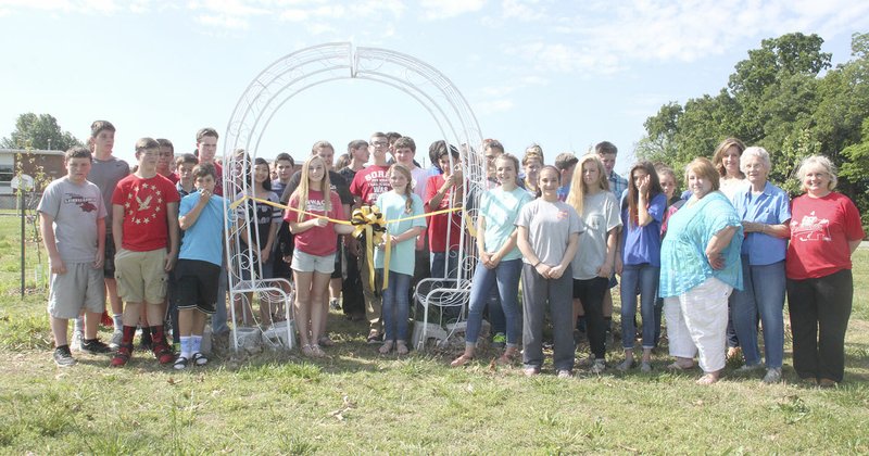 LYNN KUTTER ENTERPRISE-LEADER Jasmine Lor, a seventh-grader at Prairie Grove Middle School, waters lettuce at a new community garden created by the school&#x2019;s EAST program.