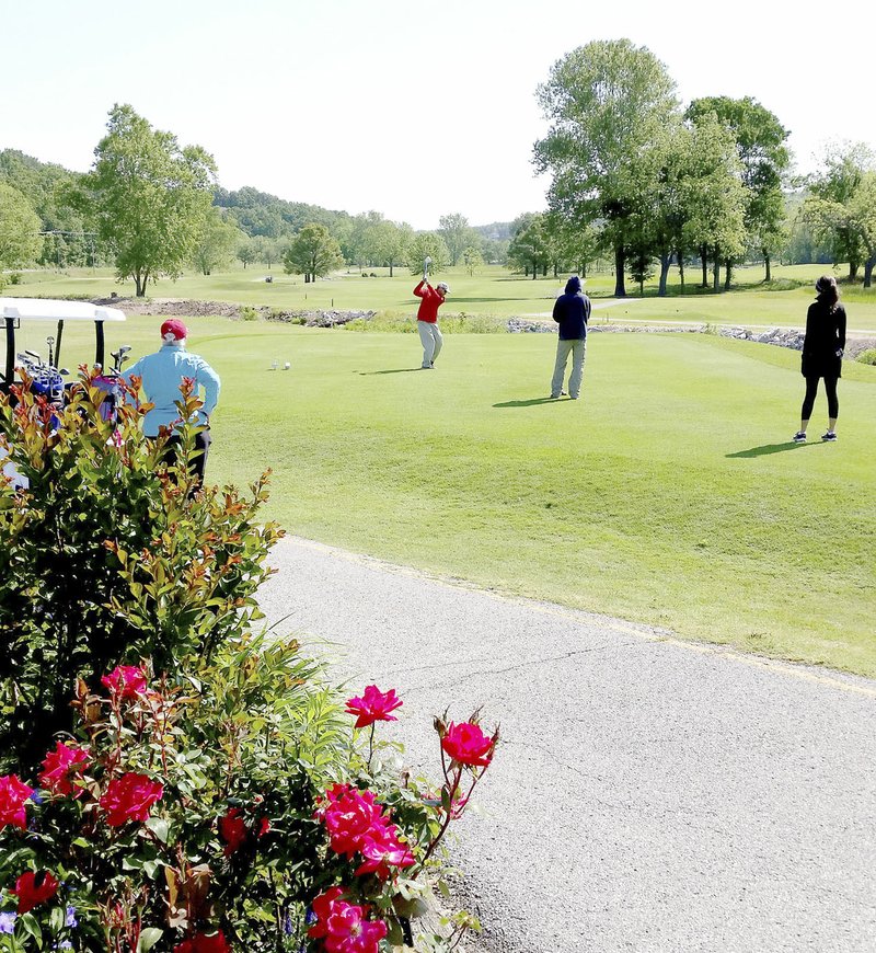 Photo submitted Chuck Janzen tees off on the No. 5 hole at Scotsdale Golf Course while Marilyn Janzen, left, Wayne Stewart, center, and Breanna Dubois watch.