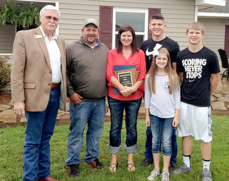 Submitted by Benton County Benton County Judge Bob Clinard, left, is shown with the Moorman family of Gravette on Tuesday. The Moorman family was named as the Benton County Farm Family of the Year.