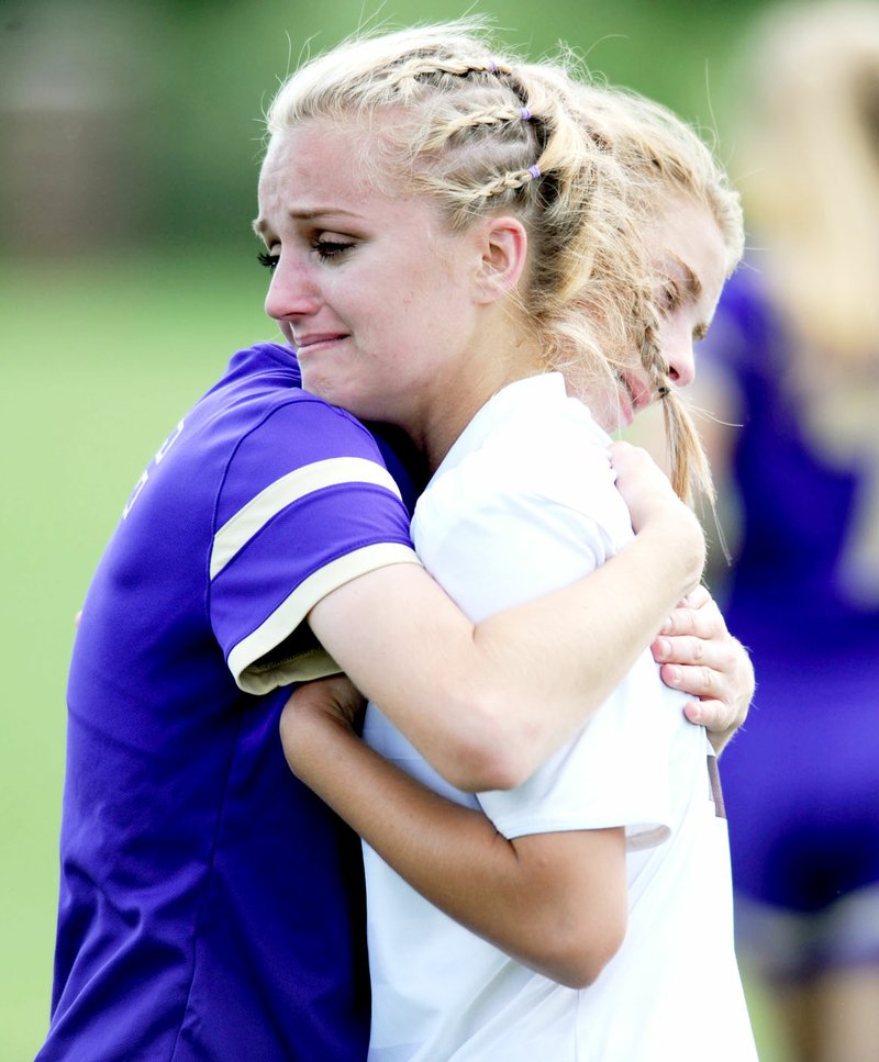 NWA Democrat-Gazette/ANDY SHUPE Gentry&#8217;s Desiree-Ana Linch (center) gets a hug from Central Arkansas Christian&#8217;s McKenna Moore Saturday, May 21, 2016, during the Class 4A state championship game at Razorback Field in Fayetteville. Visit nwadg.com/photos to see more photographs from the game.