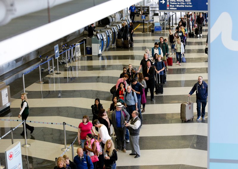 In this May 16, 2016 file photo, a long line of travelers waiting for the TSA security check point at O'Hare International airport in Chicago.