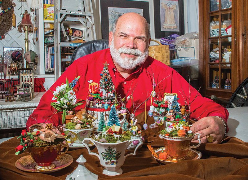 Jim Gatling, art teacher at Sacred Heart Catholic School in Morrilton, sits behind his display of teacup villages. Gatling is retiring from teaching after 41 years, including the past 11 at Sacred Heart.