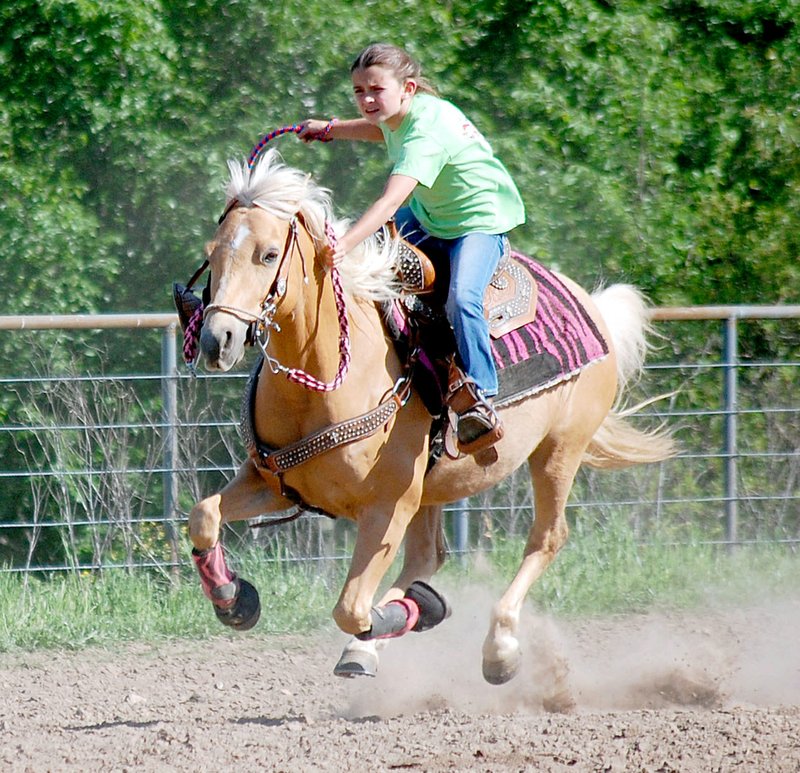 Avery Prince raced down the home stretch after completing a pole-bending pattern during the NWA Riding Club play day on April 23.