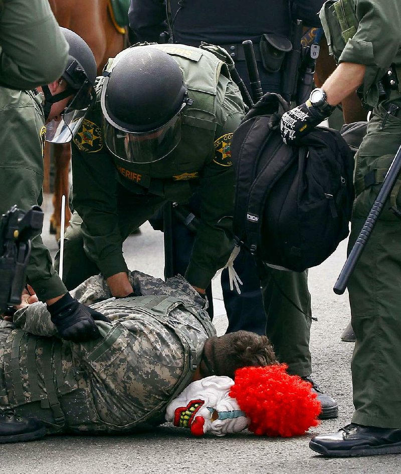 Orange County, Calif., deputies detain a demonstrator Wednesday outside a Donald Trump rally in Anaheim, Calif. Five people were arrested during the protest. 
