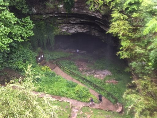 People exit Hidden River Cave after officials said over a dozen people who exploring the cave were trapped by rising water Thursday, May 26, 2016, in Horse Cave, Ky. 