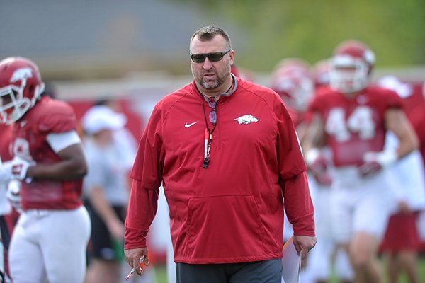 Arkansas head coach Bret Bielema works with the Razorbacks during practice Thursday, April 21, 2016 in Fayetteville.