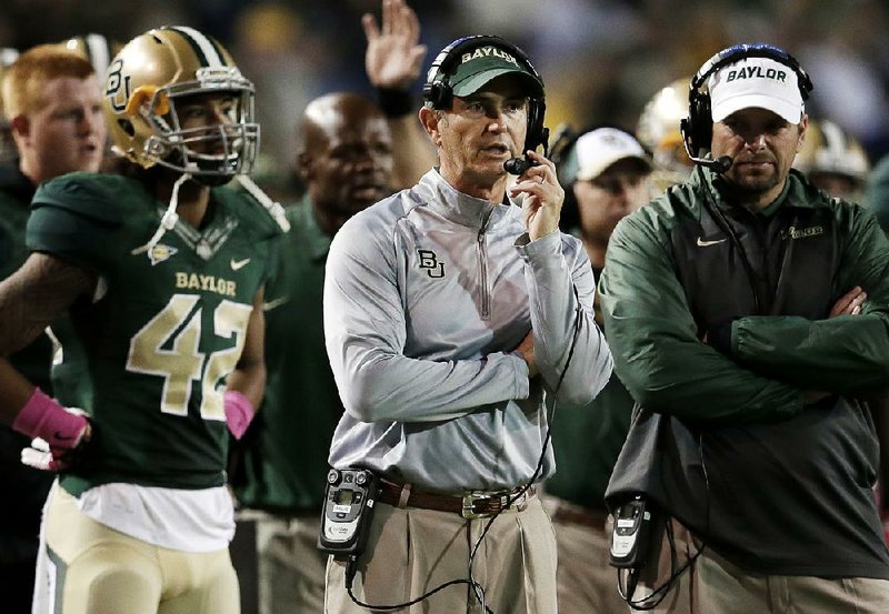 Former Baylor Coach Art Briles (center) was fired by the university in response to questions about its handling of sexual assault complaints against players. The university suspended Briles “with intent to terminate” early Thursday and demoted university president Ken Starr.