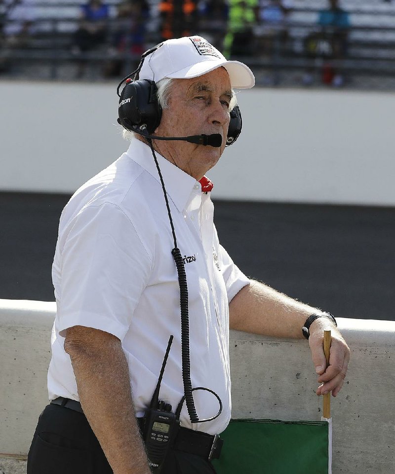 Roger Penske waits to wave the green flag for Helio Castroneves, of Brazil, qualifying attempt for the Indianapolis 500 auto race at Indianapolis Motor Speedway in Indianapolis, Sunday, May 22, 2016. 