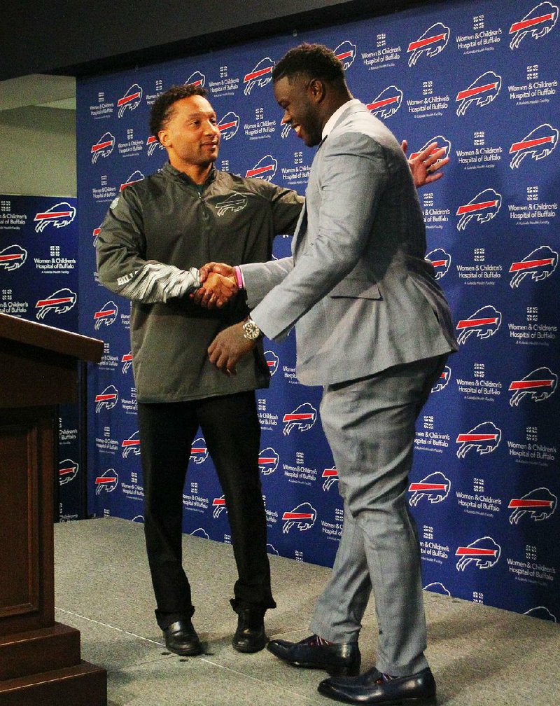 Buffalo Bills General Manager Doug Whaley (left) backpedaled a bit after drawing criticism over a comment he
made during a radio interview.