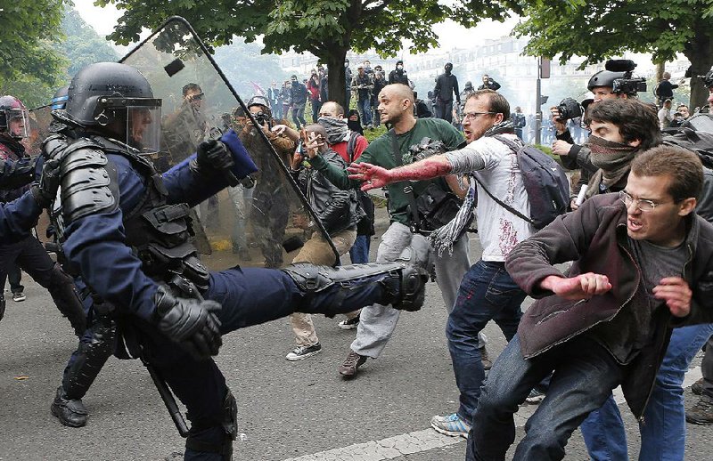 Police clash with protesters Thursday in Paris as activists and workers nationwide held rallies and strikes. 
