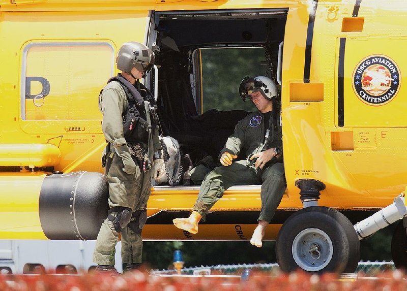 A Navy aviator involved in a crash Thursday of two Navy jets waits to get off a Coast Guard helicopter that took him to a hospital in Norfolk, Va.