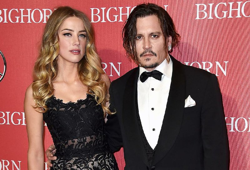 FILE - In this Jan. 2, 2016 file photo, Amber Heard, left, and Johnny Depp arrive at the 27th annual Palm Springs International Film Festival Awards Gala in Palm Springs, Calif. Court records show Heard filed for divorce in Los Angeles Superior Court on Monday, May 23, 2016, citing irreconcilable differences. 
