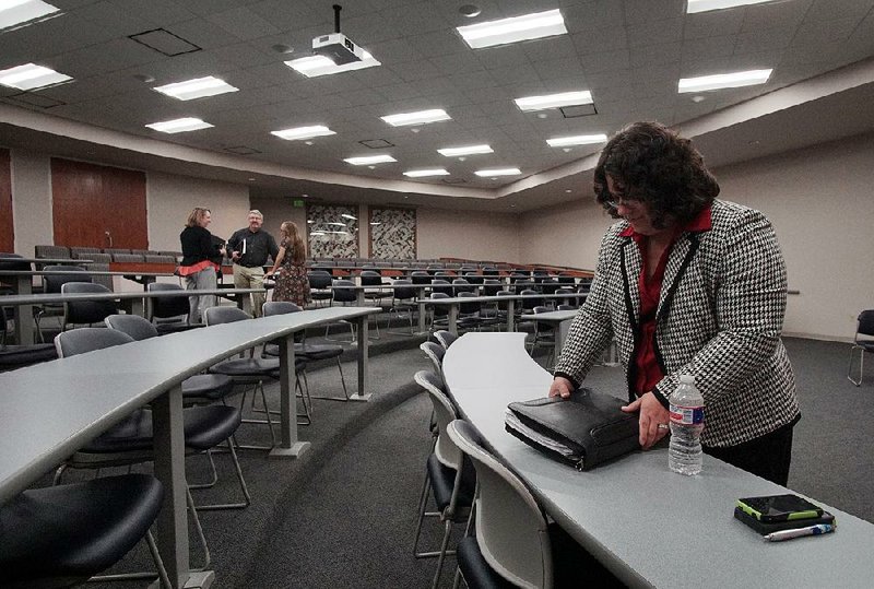 Dawn Stehle, director for the Medical Services Division of the Arkansas Department of Human Services, packs up Thursday after receiving no comments at a public hearing in Little Rock on the state’s Arkansas Works waiver application.