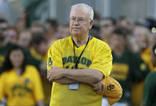 In the Sept. 12, 2015, file photo, Baylor President Ken Starr waits to run onto the field before an NCAA college football game in Waco, Texas. Baylor University's board of regents says it will fire football coach Art Briles and re-assign Starr in response to questions about its handling of sexual assault complaints against players. The university said in a statement Thursday, May 26, 2016, that it had suspended Briles "with intent to terminate." Starr will leave the position of president on May 31, but the school says he will serve as chancellor. (AP Photo/LM Otero, File)