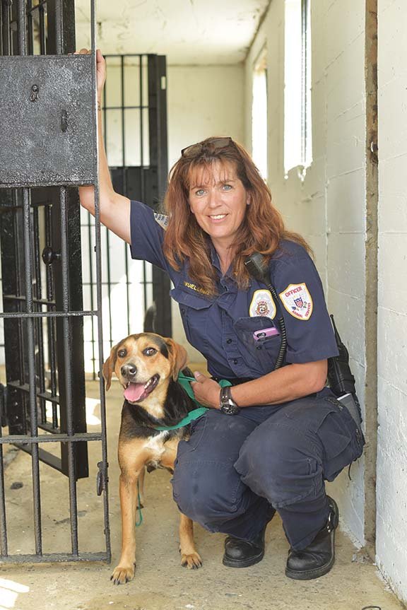 Hedy Wuelling, animal-control manager for the Jacksonville Animal Shelter, poses with Addison, a pregnant hound mix who lives at the shelter, at the old Jacksonville jail. The Bail for Fur Babies fundraiser will take place Saturday at the jail and will benefit the shelter and the Jacksonville Historical Society.