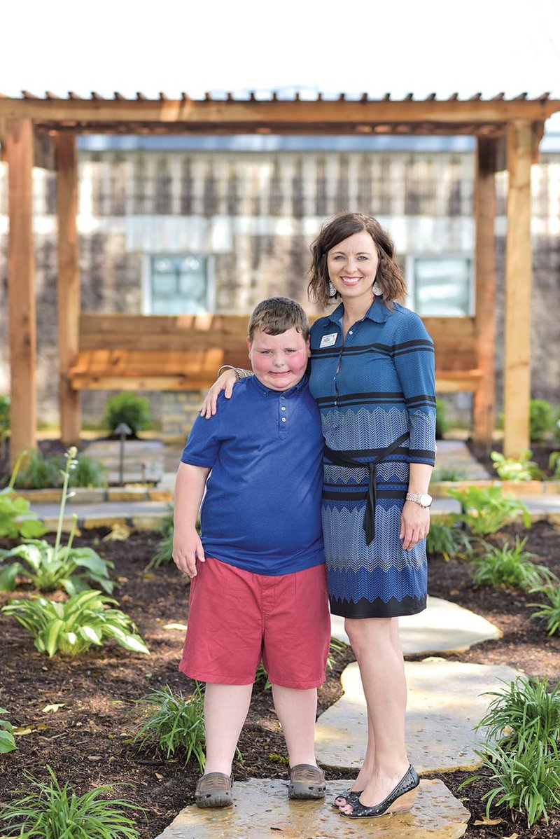 Holly Crutchfield, the mother of Noah, left, mentors and guides fellow parents of children with autism in her role as diagnostic clinic coordinator at the REACH Pediatric Health Services Autism Center in Bryant. 