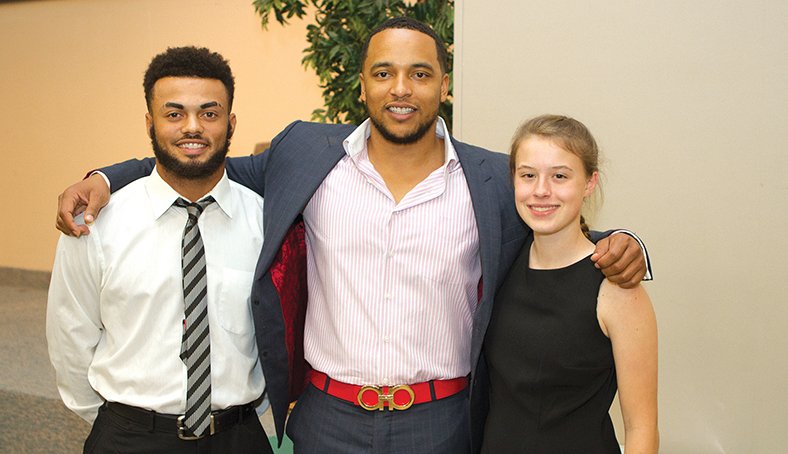 Terrance Armstard/News-Times Kevin Payne, keynote speaker of the 19th annual Union County Scholar-Athlete banquet poses with Keiandre Purifoy (left) and Krisanna Reynolds (right) Thursday evening at the College Avenue Church of Christ. 