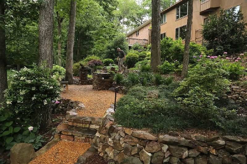 up from the garden to the house is a view of stone walls and stairs, paths and greenery, all built and tended by homeowner Allen Klak.