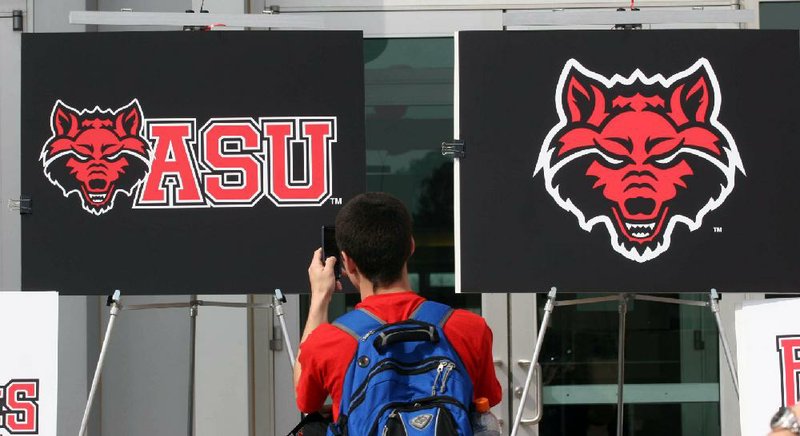 A student photographs the Arkansas State University logo on March 13, 2008.