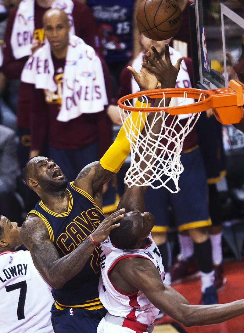 Cleveland’s LeBron James (left) puts up a shot over Toronto center Bismack Biyombo during the Cavaliers’ 113-87 victory over the Raptors on Friday in Game 6 of the NBA Eastern Conference final at the Air Canada Centre in Toronto. James will play in the NBA Finals for a sixth consecutive season.