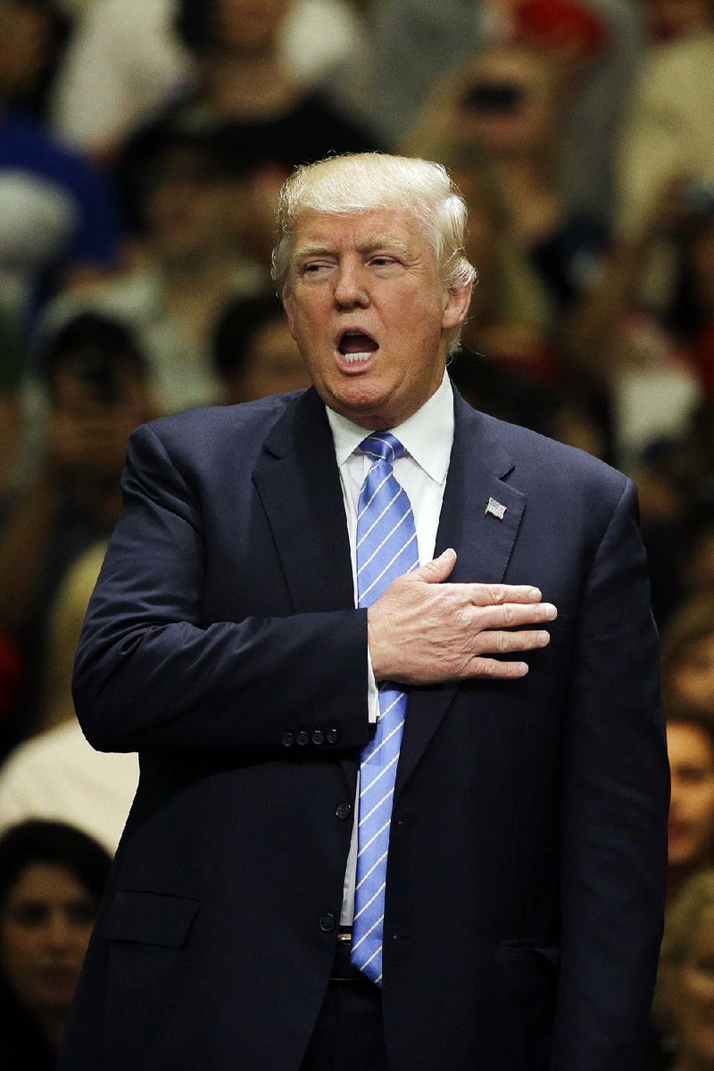 Republican presidential candidate Donald Trump sings the National Anthem during a rally at the Anaheim Convention Center, Wednesday, May 25, 2016, in Anaheim, Calif.