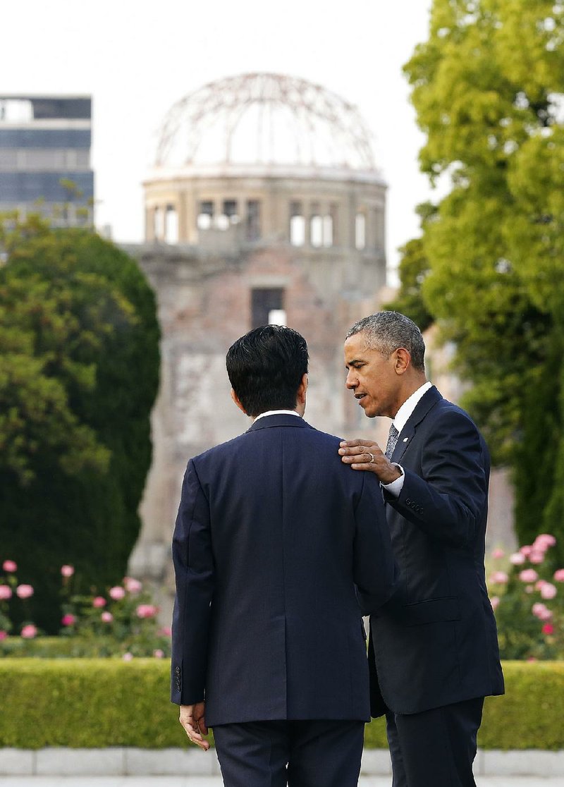 Japanese Prime Minister Shinzo Abe and President Barack Obama stand at the Hiroshima Peace Memorial Park in western Japan on Friday after laying wreaths for atomic bomb victims.