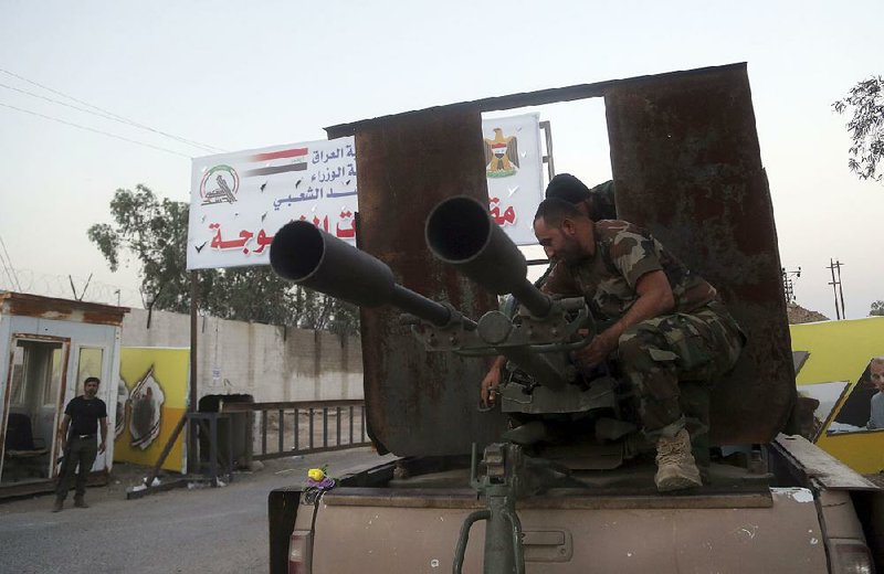 Iraqi security forces on the outskirts of Fallujah prepare Friday to surround the city. 