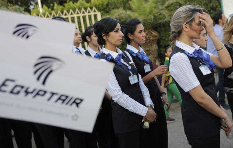 EgyptAir hostesses line up during a candlelight vigil for the victims of EgyptAir flight 804 in Cairo, Egypt, Thursday, May 26, 2016. 