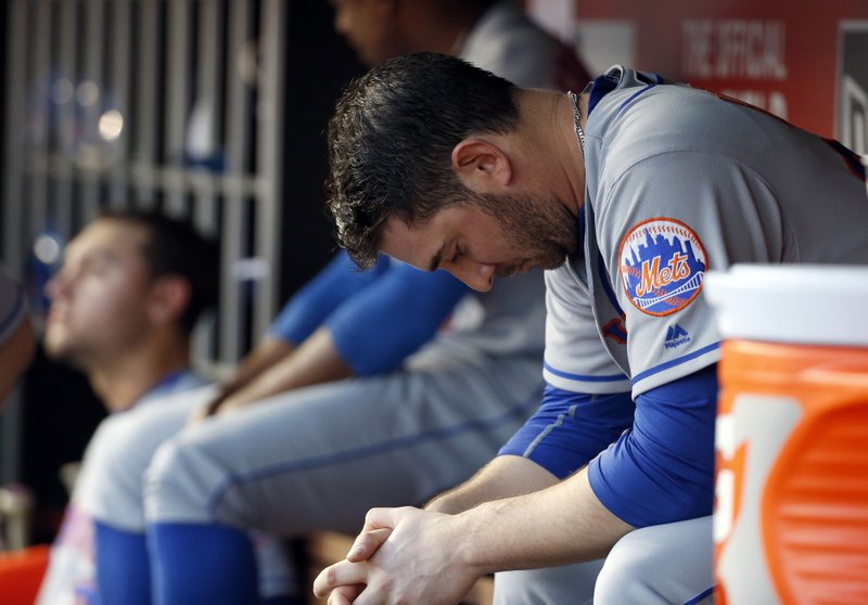 New York Mets starting pitcher Matt Harvey sits in the dugout during the fourth inning of a baseball game against the Washington Nationals at Nationals Park, Tuesday, May 24, 2016, in Washington. 
