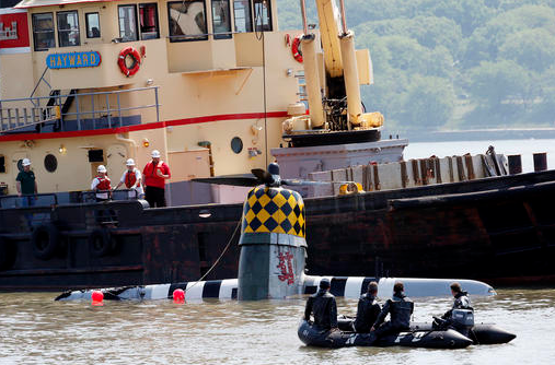 Officials remove a plane out of the Hudson River on Saturday, May 28, 2016, a day after it crashed in North Bergen, N.J.  