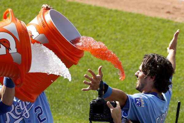 Kansas City Royals' Brett Eibner is doused by teammates after hitting the game-winning single during the ninth inning of a baseball game against the Chicago White Sox on Saturday, May 28, 2016, in Kansas City, Mo. The Royals rallied for seven runs in the inning and won 8-7. (AP Photo/Charlie Riedel)